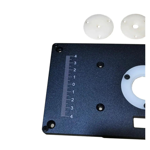 Close-up of Commercial Grade Aluminum Router Table Insert Plate with precision marking and white centering bushings.