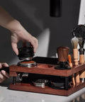 Solid Walnut Coffee Tamping Station And Espresso Knock Box Featuring Double Layer Accessory Storage Fits 51 54 58mm Portafilters, shown in use.