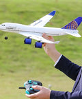 Beginner Friendly Four Motor RC Airplane With 2 4G Remote Control held outdoors