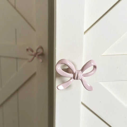 Pink Bow Drawer Pulls And Cabinet Knobs Set, 6 Pack, Solid Metal Handles For Dresser, Vanity, And Kid Friendly Furniture, Adorable Nursery Chic Accent, Easy Swap, Durable And Modern pink bow knob on white cabinet door