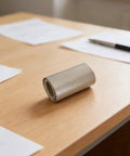 Rolled mica paper sheet cylinder on wooden desk, focus keyword: Mica Paper Sheet 13x4 Inches Pro Grade High Temperature Flexible Insulation
