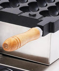 Detailed view of wooden handle on the dual heating plates of the Commercial 1800W Bubble Skewer Waffle Ball Machine.