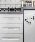 Solid Heavy Duty Jasper Cabinet Pulls Set 10 Pack Polished Chrome 5 Inch Center to Center Kitchen Cupboard Drawer Handles installed on white cabinets