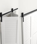 30 Inch Bi Folding Sliding Barn Door Hardware Track Kit with smooth quiet operation, side mounted black rollers, installed view.