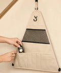 Camping Storage Organizer For Camping Rack Side Bag With Rugged Outdoor Shoe Pocket And RV Organization, hands adding gear