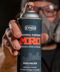Industrial High Solids Spray Paint Primer In Light Gray, 17 Oz, Heavy Duty Rust And Weather Protection can in hand.