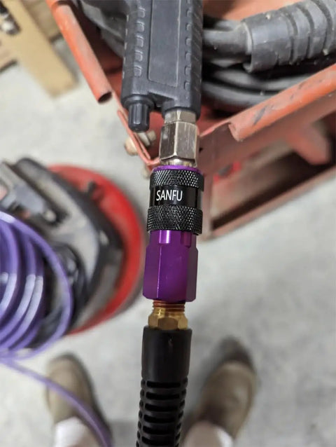 Close-up of One Quarter Inch Polyurethane Air Hose Reinforced Lightweight Compressor Tubing with purple connector fittings.