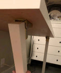 Four Pack Rock Solid Folding Brackets With Self Locking Hinges And Angle Fittings For Table Legs under a folding table with locking hinges.