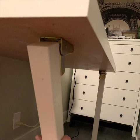 Four Pack Rock Solid Folding Brackets With Self Locking Hinges And Angle Fittings For Table Legs under a folding table with locking hinges.