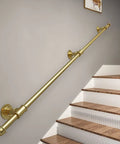 Heavy Duty Adjustable Round Tube Railing Kit For Decks And Stairs mounted on a wall beside wooden stairs.