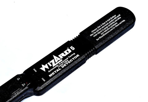 Close-up view of Lumber Wizard 5 metal detector handheld unit, black with white branding.