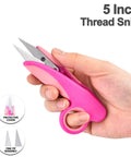 5 Inch Thread Snip with pink handle, fine-tip stainless steel blades, held in hand with protective cover