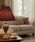 Rich Red Empire Pleated Spider Lamp Shade with Brass Fitter on vintage-style lamp in cozy living room setting