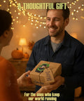 Person smiling and handing a decorated gift box labeled Carelite, with string lights and pumpkins in the background.