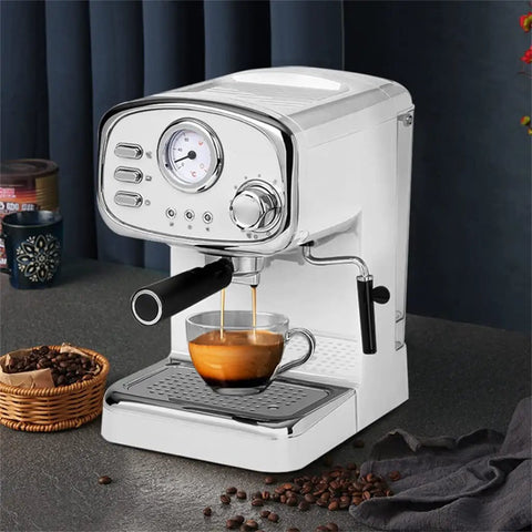 No Drama Stainless Steel Electric Coffee And Milk Frother Machine With Clear Removable Water Tank brewing espresso into a glass.