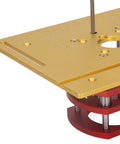 Top Shelf Aluminum Router Table Insert With Manual Lift Control For No Sweat Woodworking And Crisp Corner Beveling Built Tough Weekend Shop Essential Gold close-up of the gold surface and red lift mechanism