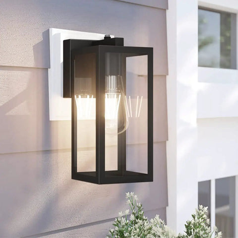 Dusk To Dawn Photocell Sensor Black Outdoor Wall Lantern With Clear Glass Shade on porch wall, bulb lit, sunny day