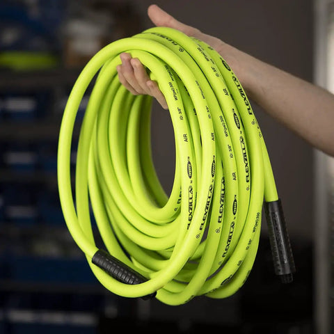 Person holding Heavy Duty Air Hose One Half Inch By Twenty Five Feet With Three Eighths Inch MNPT Fittings Hybrid Polymer ZillaGreen