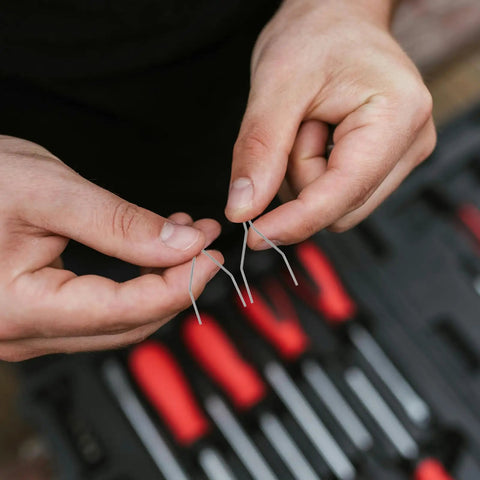 Hands holding silver staples from the 100 Piece Car Bumper Repair Welder Staples Kit For Plastic And Auto Body Fixes Versatile Welding Staples For Patching Bumpers And Other Plastics Durable Metal Silver Finish Easy On The Go Auto Body Repairs
