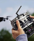Person using Ten And Twelve Channel Radio Transmitter And Receiver With Beefed Up Long Range And DSSS FHSS Tech For Airplanes Jets FPV Racing Drones.
