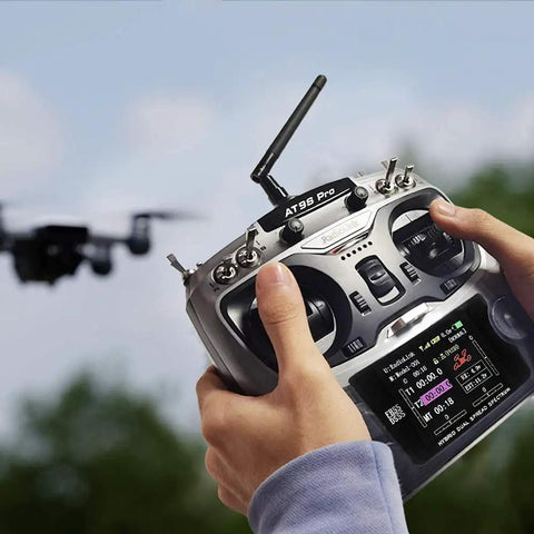 Person using Ten And Twelve Channel Radio Transmitter And Receiver With Beefed Up Long Range And DSSS FHSS Tech For Airplanes Jets FPV Racing Drones.