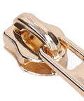 Close-up of a light gold zipper slider from the 5 Piece Zipper Sliders Set For Quick On The Go Fixes Detachable Reusable Zipper Pulls Replacement Kit.
