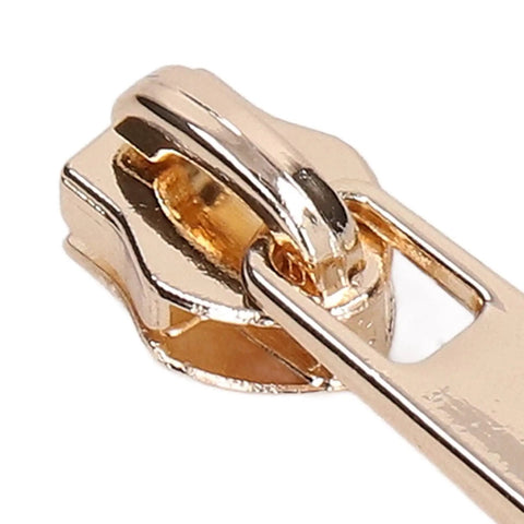 Close-up of a light gold zipper slider from the 5 Piece Zipper Sliders Set For Quick On The Go Fixes Detachable Reusable Zipper Pulls Replacement Kit.