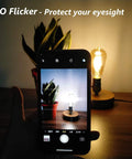 Dimmable Edison LED Bulbs Vintage Style 4W Amber Glass ST64 E26 Warm White 2200K-2400K with squirrel cage filament, no flicker feature displayed on a phone.