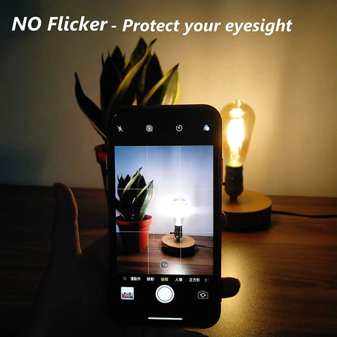 Dimmable Edison LED Bulbs Vintage Style 4W Amber Glass ST64 E26 Warm White 2200K-2400K with squirrel cage filament, no flicker feature displayed on a phone.