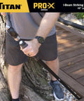 Person using Heavy Duty 48 Inch I Beam Striking Bar With Angled Chisel End And Reinforced Strike Cap outdoors against tree.