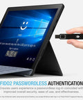 Person holding FIDO2 Fingerprint USB A Security Key for Passwordless Login near a Windows tablet screen.