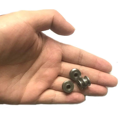 U Groove Ball Bearing 4x13x7mm Deep Groove Pulley Rail Bearing Mini Wheel Set 20 Pack U624ZZ in hand, steel U-groove bearings