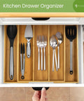 Expandable Bamboo Kitchen Drawer Organizer For Utensils And Flatware, 3 To 5 Slots, showing organized cutlery in a drawer.