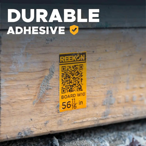 Close-up of durable adhesive label on wood marked with QR code, showcasing P1L Portable Bluetooth Thermal Construction Label Printer For Jobsites With QR Codes And One Click Labels Battery Powered Quick Templates Rugged Mobile Label Maker For Materials And Locations use.