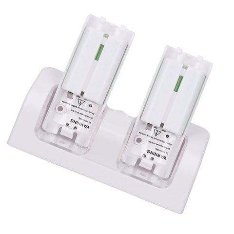 Dual Remote Charger Dock With Built In 2800mAh Batteries For Game Consoles And Smart TVs 4 In 1 Remote Charging Station Easy Drop In Recharge Without Battery Swaps Portable ABS Base In White Fast And Efficient Power showing overhead view of charging dock with batteries inserted