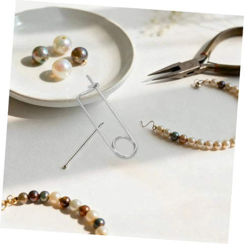 Ditch The Loose Ends With These Cool Nolis Spring Pins, Stainless Steel Quick Lock Clamps For Garden Hooks And Heavy Machinery Tasks That Stay Put, displayed with pearls and jewelry tools.