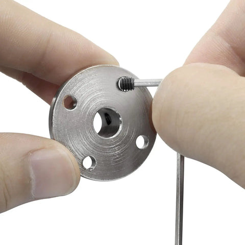 Close-up of hand holding a metal component from Rigid 8mm Flange Coupling Connector Set with hex wrench and screw for DIY RC models.