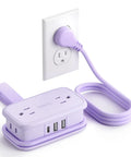 Purple Travel Power Strip With Four Outlets And Three USB Ports Including USB C Four Foot Wrapped Extension Cord plugged in.