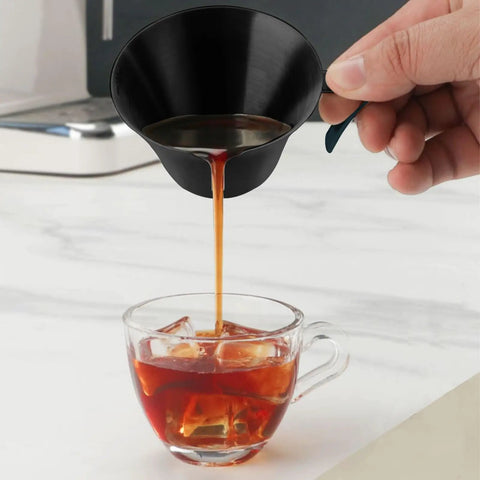 Pouring espresso from Stainless Steel Espresso Shot Cups With Spout And Handle, V Shaped Mouth For Clean Pour, into glass