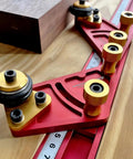 Pro Grade Portable Aluminum Table Saw Roller Feeder Dolly Featuring Smooth Ball Bearings on a wooden surface with measuring scale.