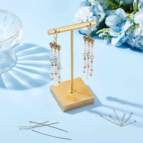Real 14K Gold Plated Brass Pins Set Dope 180 Pcs 9 Styles Eye Pins Ball Head Pins Flat Head Pins 24 Gauge Eye Pins 23 Gauge Flat Pins For DIY Jewelry Making Earring And Bracelet Crafter Kit displayed with finished earrings