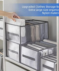 Hand organizing clothes in Six Piece Extra Large Closet Organizer And Storage Set for shirts, jeans, and sweaters on shelf.