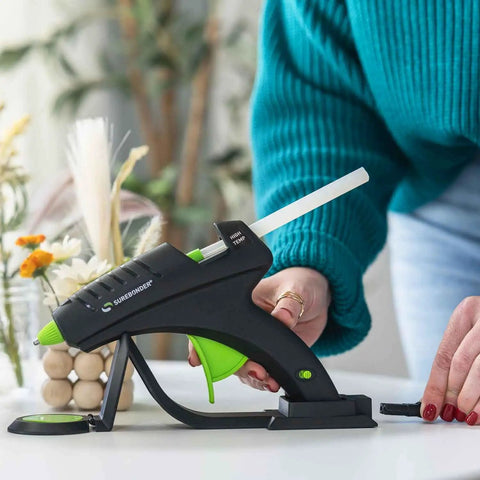 Cordless High Temperature Glue Gun 60W with Standby Base in use for crafting on a table