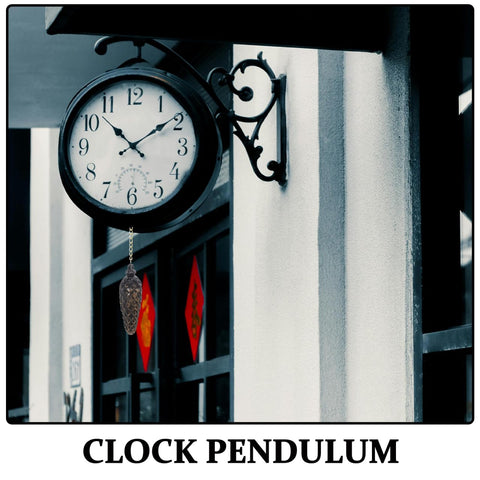 Outdoor wall clock with pendulum on ornate bracket, next to building entrance