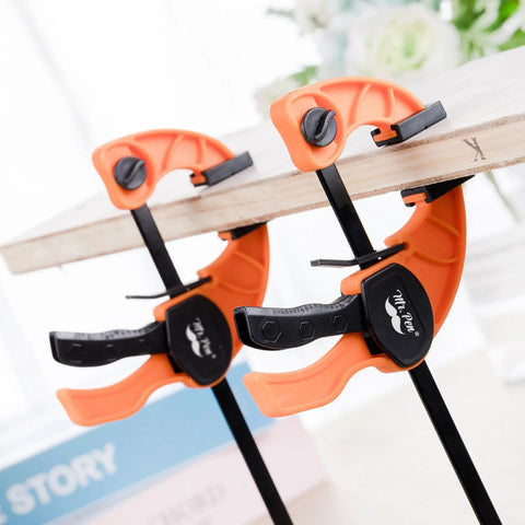 Mr. Pen orange 6-inch bar clamps, 2-pack, woodworking, two clamps gripping a wooden board with black handles