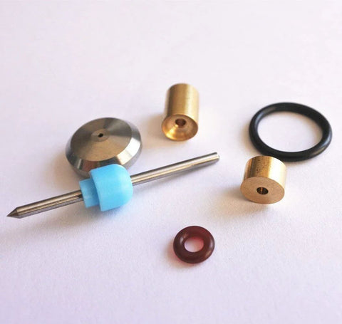 Waterjet on/off valve repair kit parts, front view: brass fittings, steel rod with blue guide, metal disk, and O-rings.