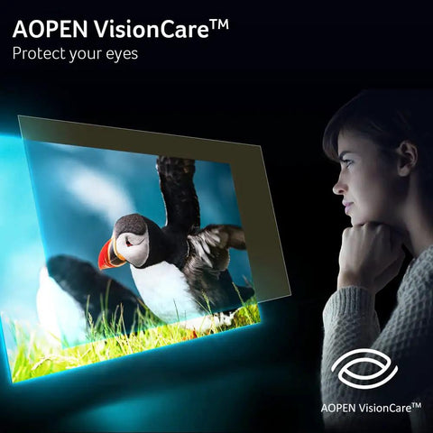 Woman watching AOPEN VisionCare display with a puffin on screen, promoting eye protection technology.