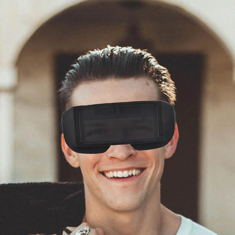 Smiling man wearing Badass Auto Darkening Welding Goggles Featuring Kickin Wraparound Coverage And Legit Precision Lenses.