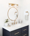 Gold Three Light Vanity Fixture With Clear Glass Globe Shades For Bathroom Modern Soft Gold Finish 22 Inch Long Vanity Lighting Bar Crystal Ball Style Bath Lighting For A Lux Look mounted above mirror