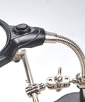 Close-up of 4X LED Magnifier Soldering Station with light, showing adjustable arm and auxiliary clips for precise DIY projects.